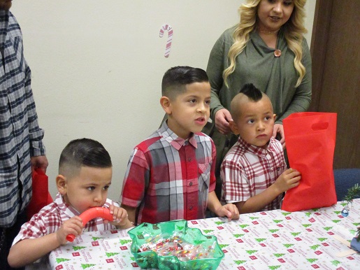 A family at the Christmas Party receiving a Braille Christmas Ornament
